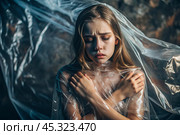 The girl is wrapped in cellophane or a bag. The girl is suffocating. Plastic pollution of the planet. Environmental hazard. Reducing the reuse of plastic. Recycling. The concept of garbage. Стоковое AI-изображение, AI-художник Photojuli / Фотобанк Лори