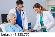 Medical consultation with patient undergoing computer test, healthcare professionals analyzing results on laptop in clinic office, modern medical examination process. Стоковое AI-изображение, AI-художник Павел Муравьев / Фотобанк Лори