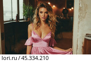 Boho style young woman in light pink dress, comfortably, tranquility in her demeanor, indoor environment, pastel tones, epitome of casual sophistication, peaceful vibes. Стоковое AI-изображение, AI-художник Павел Муравьев / Фотобанк Лори