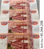 Close-up of Russian rubles. Row of 5000 ruble banknotes on table. Money financial background. Flat lay, close-up, top view. Стоковое фото, фотограф Виктория Катьянова / Фотобанк Лори