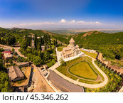 Aerial top view of the Bodbe Monastery architectural complex of St. Nino. View from above to church, Alazani Valley, Greater Caucasus mountains, in sunny summer day. Sighnaghi city, Kakheti, Georgia. Стоковое фото, фотограф Алексей Ширманов / Фотобанк Лори