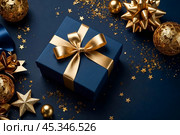 Dark blue Christmas present gift box with elegant gold bow ribbon on dark blue near stars. Greeting gift symbolize sophisticated holiday gifting. Birthday Christmas festive concept. Copy ad text space. Стоковое AI-изображение, AI-художник Aleksandr Golubev / Фотобанк Лори