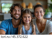 Loving young man hug his beloved wife and little daughter sit on couch in living room, happy people smiling looking at camera posing for photo picture. Exemplary family portrait, love and bond concept. Стоковое AI-изображение, AI-художник Ирина Михайличенко / Фотобанк Лори