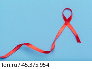 ribbon HIV, AIDS on blue background. Стоковое фото, фотограф Сергей Толмачёв / Фотобанк Лори