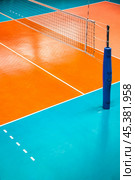 Professional volleyball court with net in sporty gym for banner, sport backdrop. Volleyball courts in sport hall, nobody. Team game success, healthy sporty lifestyle concept. Copy ad text space poster. Стоковое фото, фотограф Aleksandr Golubev / Фотобанк Лори