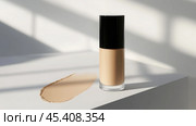 Elegant unbranded foundation cream in minimalist studio lighting for beauty product display. Стоковое AI-изображение, AI-художник Sabyna75 / Фотобанк Лори