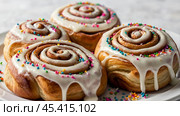 The cinnabons. Close-up of cinnamon buns. Beautiful buns with fresh cinnamon and icing on a wooden table. Fragrant homemade New Year's pastries. Стоковое AI-изображение, AI-художник Photojuli / Фотобанк Лори