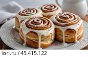 The cinnabons. Close-up of cinnamon buns. Beautiful buns with fresh cinnamon and icing on a wooden table. Fragrant homemade New Year's pastries. Стоковое AI-изображение, AI-художник Photojuli / Фотобанк Лори