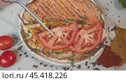 Sandwich with combination of processed cheese, meat, and vegetables. garnished with thinly sliced tomato slices, which add touch of juiciness and appeal. Стоковое видео, видеограф Strunov David / Фотобанк Лори