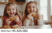 Two young girls laugh while eating gingerbread cookies in a kitchen. Стоковое AI-изображение, AI-художник Сергей Толмачёв / Фотобанк Лори