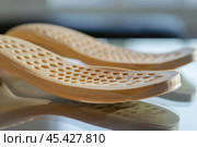Pair of modern orthopaedic shoe sole insoles for flatfoot correction. Стоковое AI-изображение, AI-художник Иван Рябоконь / Фотобанк Лори