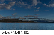 A calm blue lake. Ripples on the surface of the water. Coastal hills against the background of the evening sky and clouds. Madagascar. Mantasoa Lake. Стоковое фото, фотограф Вера Ивановна Кубарева / Фотобанк Лори