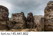 Stone monoliths and rock formations against a cloudy sky convey the grandeur and power of nature. Стоковое фото, фотограф Игорь Кляхин / Фотобанк Лори