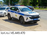 Russia. Samara, May 24, 2024: a police patrol car on a city street. text in Russian: police, Russian Interior Ministry, helpline, traffic police. Редакционное фото, фотограф Акиньшин Владимир / Фотобанк Лори