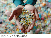 Hands Holding Assorted Microplastic Fragments. Стоковое AI-изображение, AI-художник Arsenii Palivoda / Фотобанк Лори