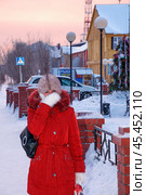 Старый Уренгой,  Ямал,  Западная Сибирь, Россия - 15 Декабря, 2011:  Зима, морозный день, женщина , стоящая около остановки в ожидании транспорта. Варежка у лица , это характерный признак того,  что на улице хороший мороз. Редакционное фото, фотограф Павел Просянов / Фотобанк Лори