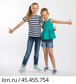 Two beautiful girls sisters, isolated on white background. Стоковое фото, фотограф Андрей Аркуша / Фотобанк Лори