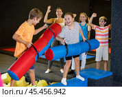 Tween girl having fun on battle beam with boy. Стоковое фото, фотограф Яков Филимонов / Фотобанк Лори