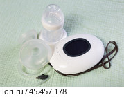 Isolated electric portable breast pump with blank bottle and replaceable nipple for feeding newborn. Стоковое фото, фотограф Яков Филимонов / Фотобанк Лори