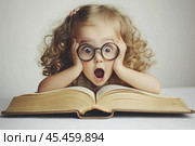 Girl is shocked by what she read in a huge book. Стоковое AI-изображение, AI-художник Дмитрий Киселёв / Фотобанк Лори