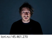 Surprised man whose face is illuminated by the light of a lantern. Стоковое AI-изображение, AI-художник Дмитрий Киселёв / Фотобанк Лори