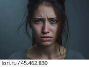 Portrait of a crying caucasian girl with bruised skin on grey studio background. Domestic violence, portrait of abused and hurt young woman crying at home. Sadness and depression concept. Стоковое AI-изображение, AI-художник Sergey Grishin / Фотобанк Лори