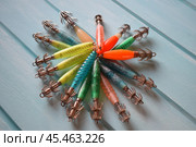 Lure for squid. Wobblers for squid on a blue background. (2017 год). Редакционное фото, фотограф Сергей Костюк / Фотобанк Лори