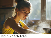 Girl rubs dust. Beautiful young woman makes cleaning the house. Caucasian housekeeper housewife washing polishing whipping furniture. Стоковое AI-изображение, AI-художник Sergey Grishin / Фотобанк Лори