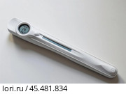 Modern basal thermometer showing temperature on white background. Стоковое AI-изображение, AI-художник Иван Рябоконь / Фотобанк Лори