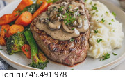 Chef is finishing preparing a delicious steak dinner with mushroom sauce. Стоковое AI-видео, аниматор Юрий Поздников / Фотобанк Лори