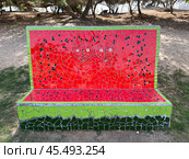 Urban sculpture in Ashdod park. Bench in the form of a cut watermelon in mosaic technique. Редакционное фото, фотограф Irina Opachevsky / Фотобанк Лори