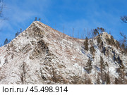 Winter landscape with snow-capped peaks of rocky mountains near Goloustnaya River on sunny January day. Baikal region, Pribaikalsky national park. Beautiful nature background. Winter travels. Стоковое фото, фотограф Виктория Катьянова / Фотобанк Лори
