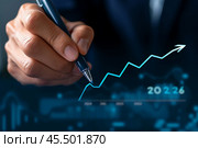 Businessman illustrating growth projections for 2024 to 2025 with a strategic arrow graph in a corporate setting. Стоковое AI-изображение, AI-художник Sergey Grishin / Фотобанк Лори
