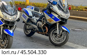Moscow November 24 2024, Two motorcycles with blue and white colors and the letters NBC on them. Редакционное фото, фотограф Скрипачев Антон / Фотобанк Лори
