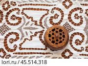 Beautiful white tablecloth with lace patterns embroidered in richelieu style or cutwork embroidery and old wooden box on wooden table. Retro still life. Handicraft for home decoration. Close-up, flat lay. Стоковое фото, фотограф Виктория Катьянова / Фотобанк Лори