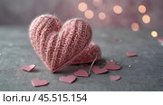 The banner. Background for Valentine's Day. Knitted hearts with festive lights in the form of a side in the background. a mock-up of an invitation card for a Valentine's Day party, a place to copy. Стоковое AI-изображение, AI-художник Photojuli / Фотобанк Лори