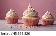 Festive cupcakes, baked with pastry sprinkles on a pink background with sequins, ideal for romantic celebrations. Valentine's Day, wedding. Стоковое AI-изображение, AI-художник Photojuli / Фотобанк Лори