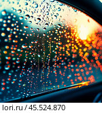 Raindrops cling to the surface of car glass, distorting a vibrant cityscape at evening, where colorful lights from traffic and buildings merge into a beautiful display. Generative AI. Стоковое AI-изображение, AI-художник Юлия Петровская / Фотобанк Лори