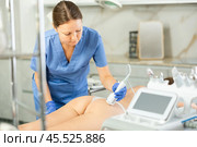 Cosmetologist makes cryo therapy lifting with skin rejuvenation and smoothing for woman use electric device equipment in spa center. Body care. Стоковое фото, фотограф Яков Филимонов / Фотобанк Лори