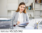 Office manager works with documents and laptop. Стоковое фото, фотограф Яков Филимонов / Фотобанк Лори
