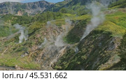 Hot springs and fumaroles in Valley of Geysers. Стоковое видео, видеограф Михаил Коханчиков / Фотобанк Лори