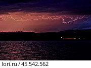 Thunderstorm and lightning on the coast of Issyk-Kul, Kyrgyzstan Soft focus (2016 год). Стоковое фото, фотограф Evgenii Predibailo / Фотобанк Лори