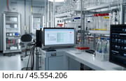 Modern laboratory setting with advanced equipment and digital displays in a scientific workspace. Стоковое AI-изображение, AI-художник Сергей Толмачёв / Фотобанк Лори