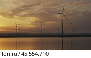Windmills turbines with sunrise reflection. Стоковое видео, видеограф Михаил Коханчиков / Фотобанк Лори