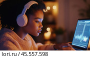 Focused audio editing session: person using laptop with headphones for creative sound design. Стоковое AI-изображение, AI-художник Sabyna75 / Фотобанк Лори