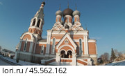 Berdsk, Russia-November, 30,2024. Religion, architecture. The Orthodox Cathedral in honor of the Transfiguration of the Lord, around which there is snow on a background of blue sky. Distortion. Siberia. Редакционное видео, видеограф Сергей Медведев / Фотобанк Лори