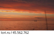 Majestic cargo ship navigating the ocean waves during a breathtaking sunset. Стоковое видео, видеограф Данил Руденко / Фотобанк Лори
