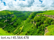 Scenic view of a deep green canyon with rocky walls in a mountainous area in cloudy weather. Стоковое фото, фотограф Константин Лабунский / Фотобанк Лори