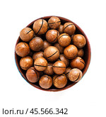 Macadamia nuts in bowl on white background, top view. Стоковое фото, фотограф Зарифа Арсланова / Фотобанк Лори