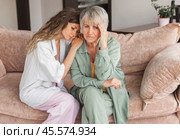 Grown up daughter soothe aged mother holds her hand feel empathy give her moral support, sad elderly woman at home. Стоковое фото, фотограф Гладских Татьяна / Фотобанк Лори